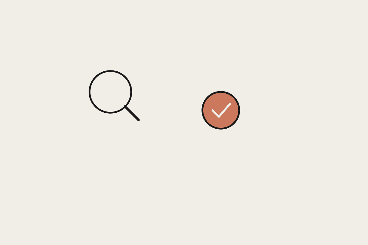 A magnifying glass beside a terracotta check mark