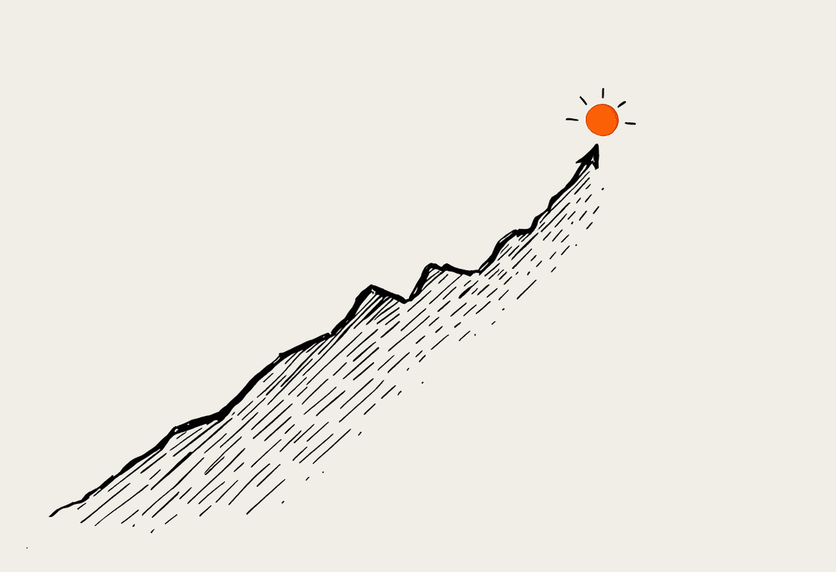 Hand-drawn upward-trending line on a notebook page ending in a small terracotta sun