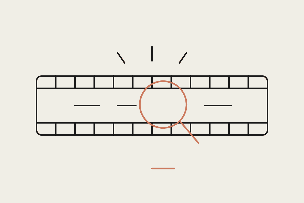 Line drawing of a filmstrip with a magnifier inspecting one segment of it
