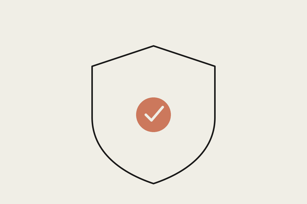 Notebook sketch of a shield with a terracotta checkmark, representing data protection